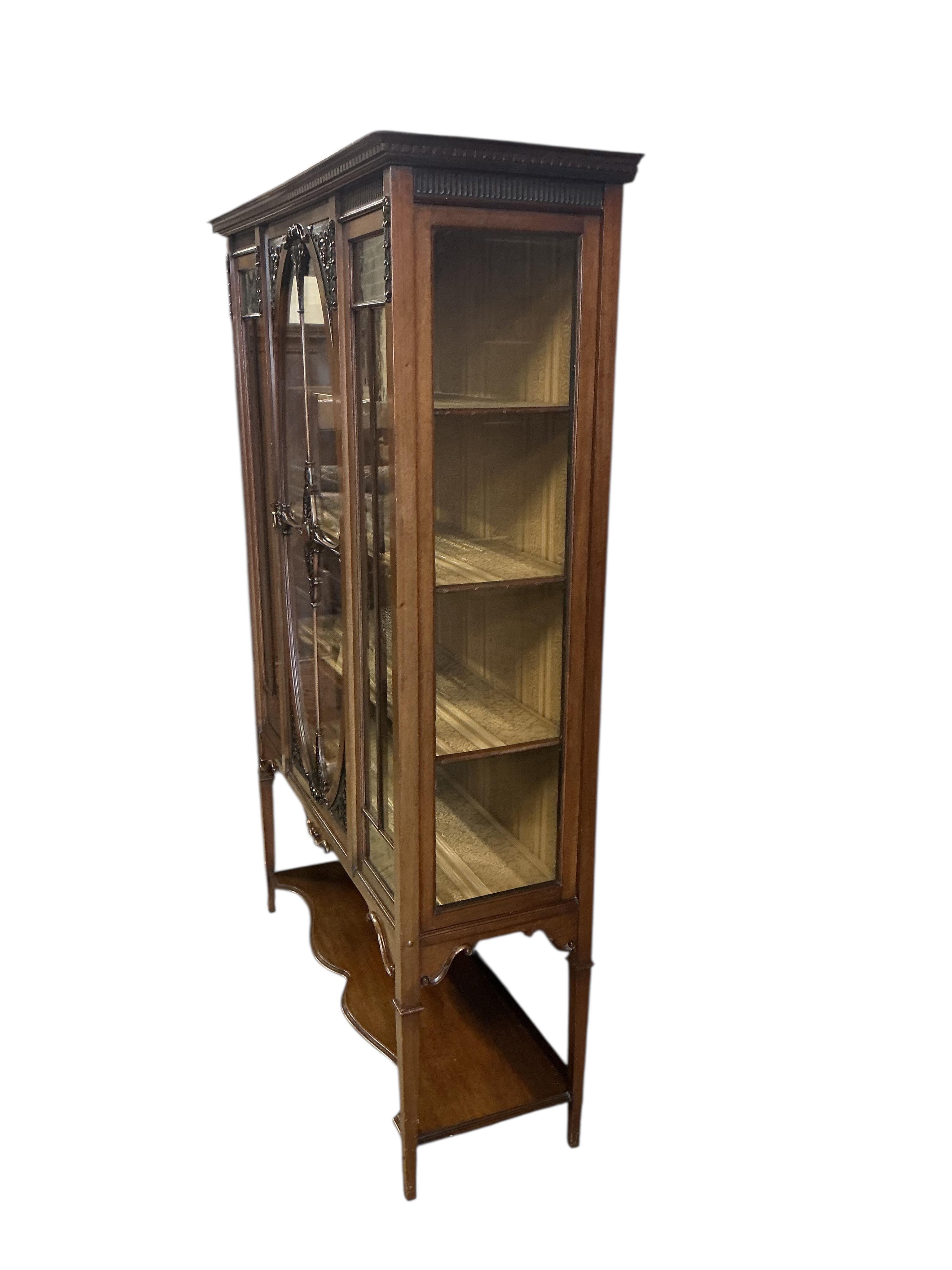 A late Victorian mahogany display cabinet, width 123cm, depth 43cm, height 180cm.